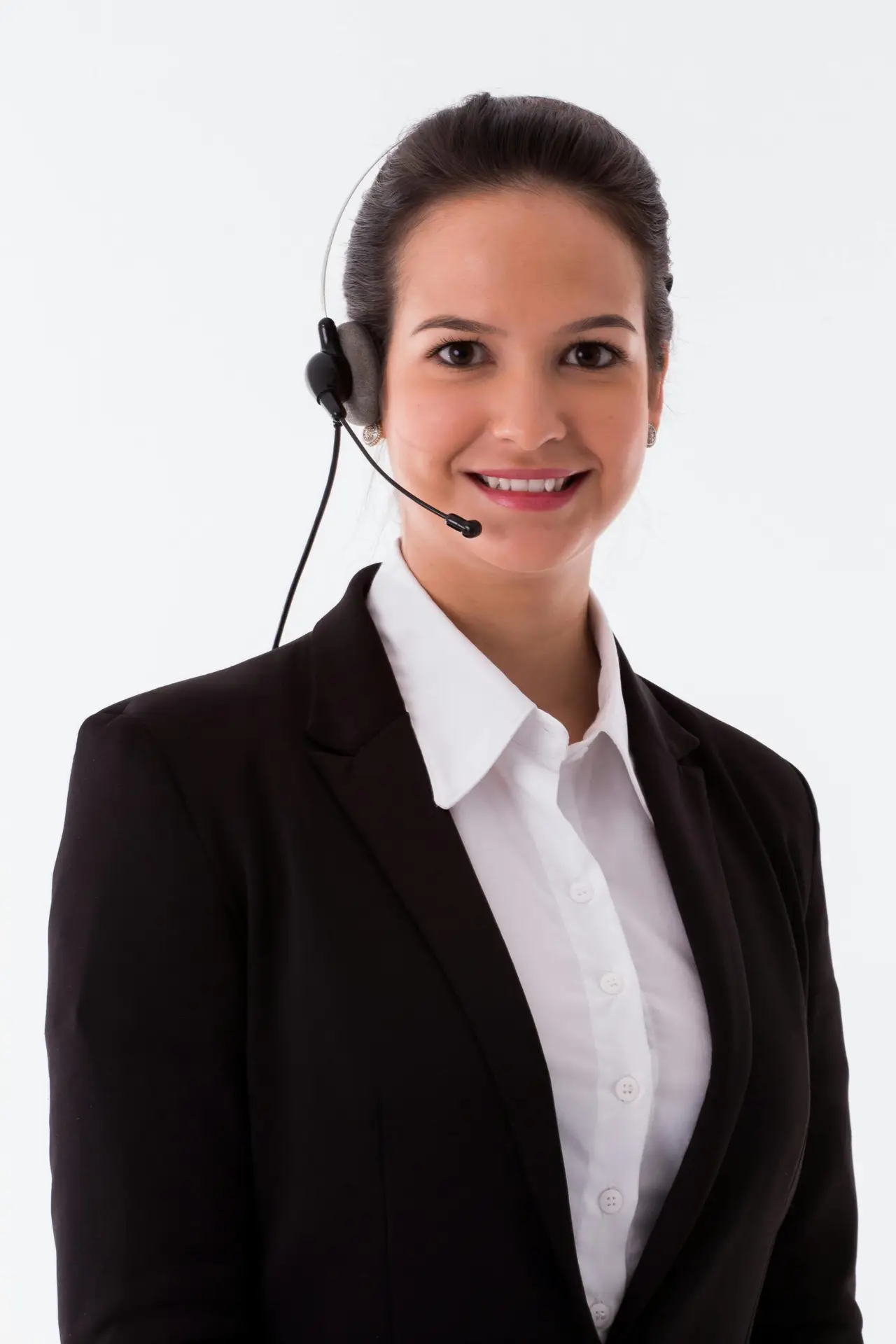 Elegant businesswoman wearing a headset in a professional studio portrait on a white background.